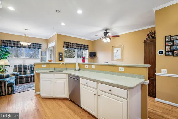 a kitchen with a sink cabinets and wooden floor