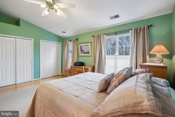 a bedroom with a large bed and a chandelier