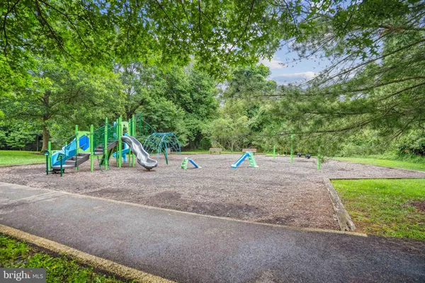 a view of outdoor space with playground and green space