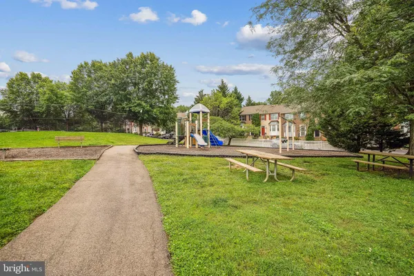 a view of a swimming pool with lawn chairs and a big yard
