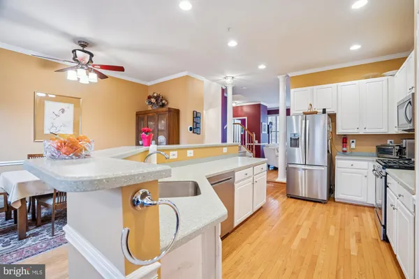 a large kitchen with stainless steel appliances granite countertop a stove and a refrigerator
