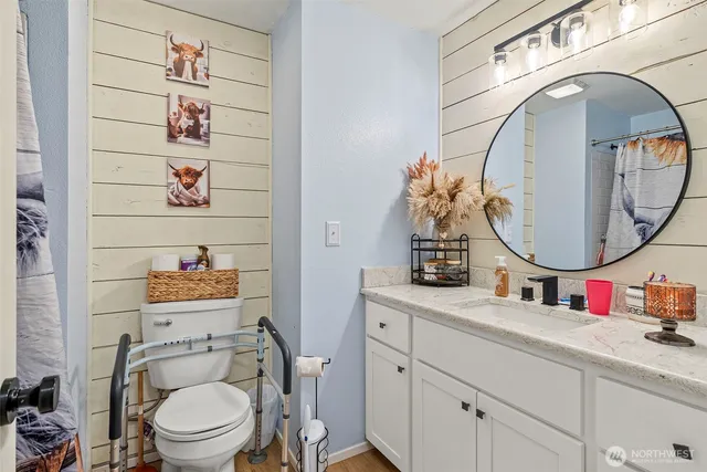 a bathroom with a toilet a sink and a mirror