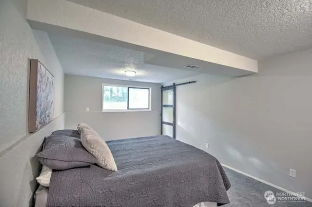 a bedroom with a bed and window