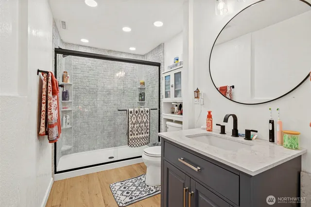 a bathroom with a sink a toilet and a mirror