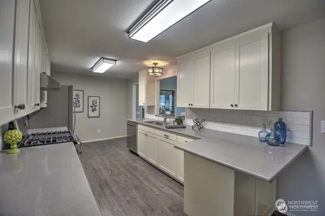 a kitchen with a sink cabinets and window