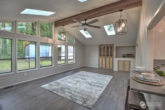a living room with stainless steel appliances granite countertop furniture and a kitchen view