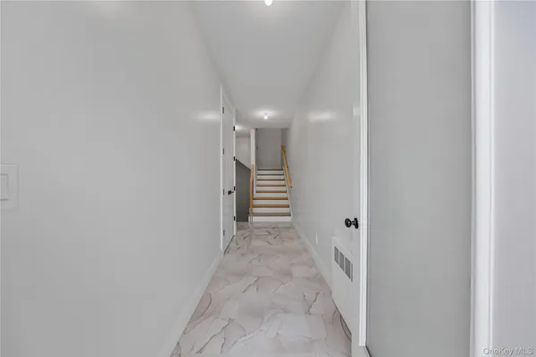 a view of a hallway with stairs