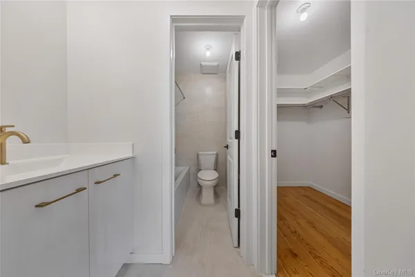 a bathroom with a granite countertop sink a toilet and shower