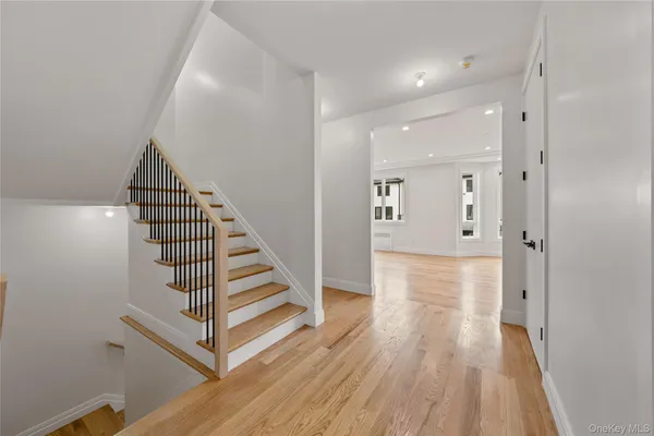 a view of a hallway with wooden floor and entryway