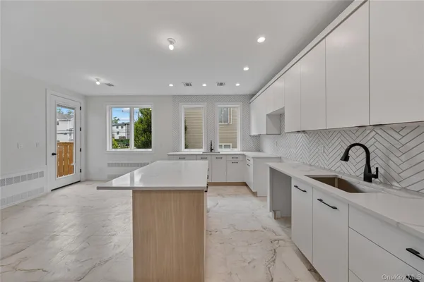 a kitchen with counter top space cabinets and appliances
