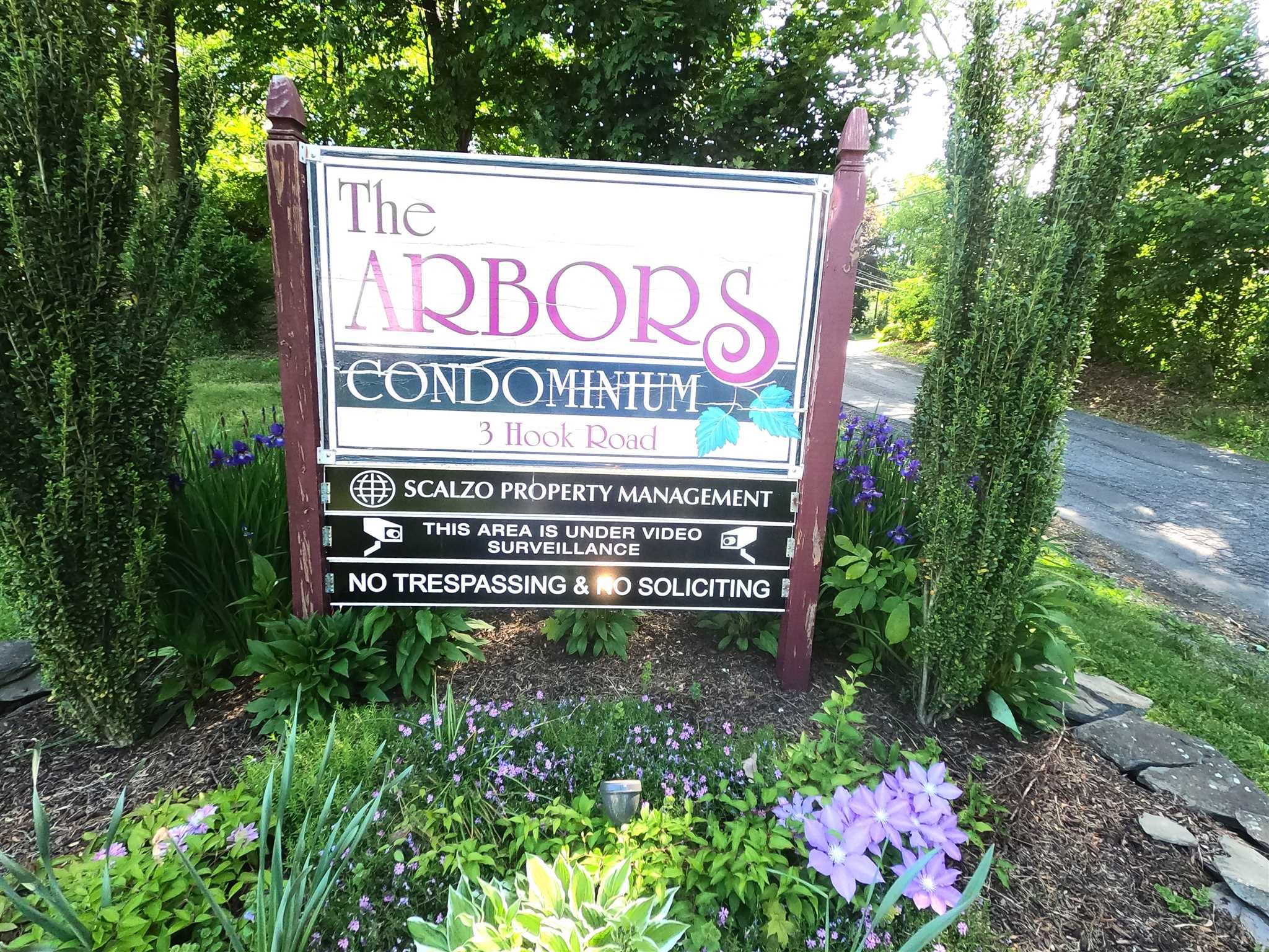 a sign that is sitting in front of flowers