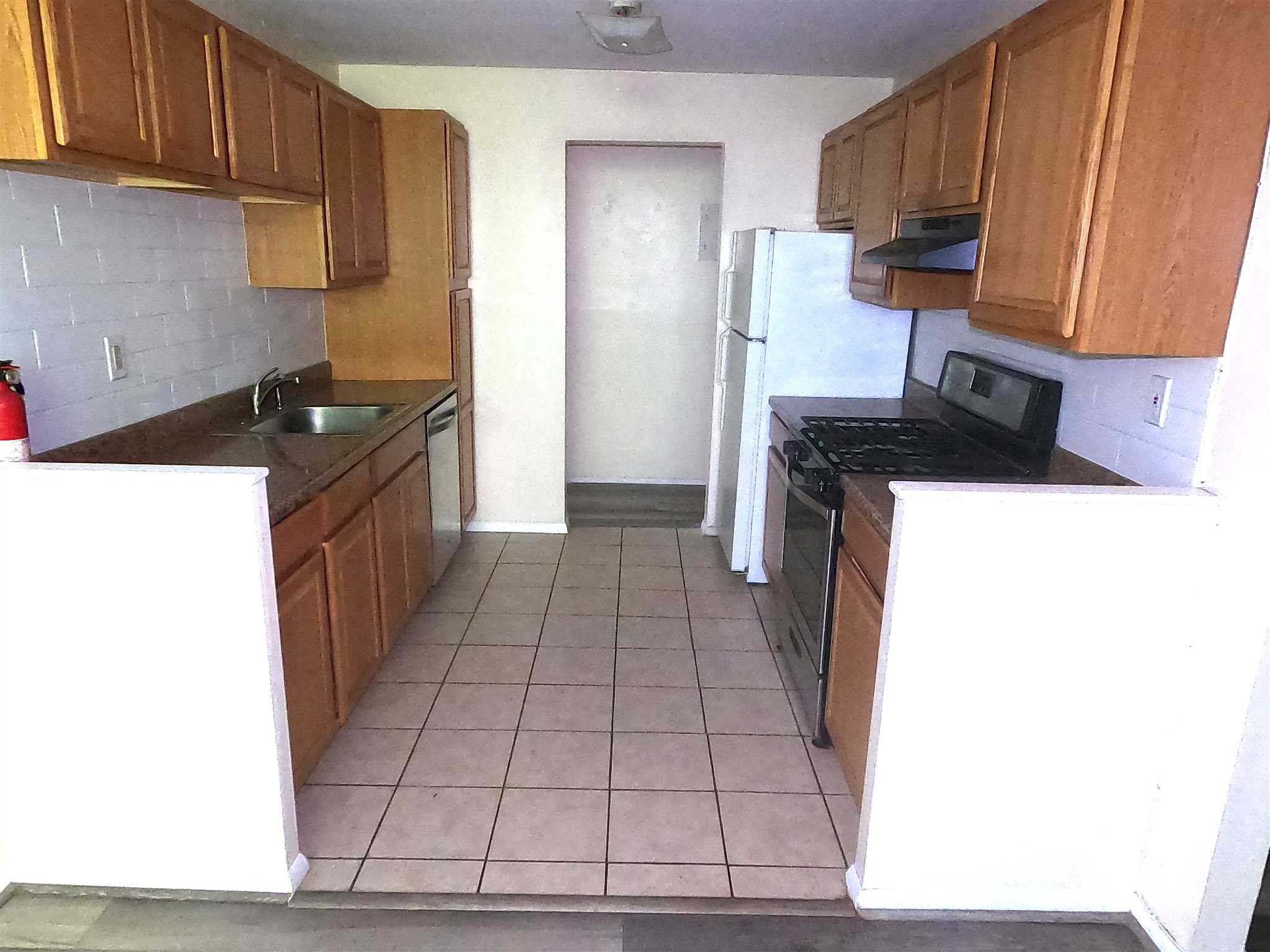 3 Hook Hyde Park, Unit 14A Poughkeepsie, NY 12601 - Photo 4 of 20 a kitchen with a sink a stove top oven a refrigerator and cabinets