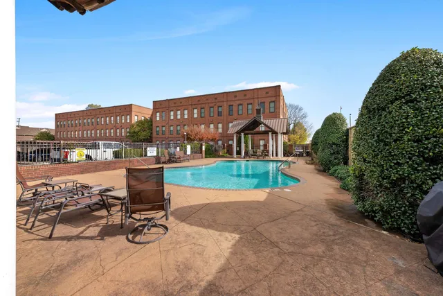 a front view of a house with swimming pool having outdoor seating