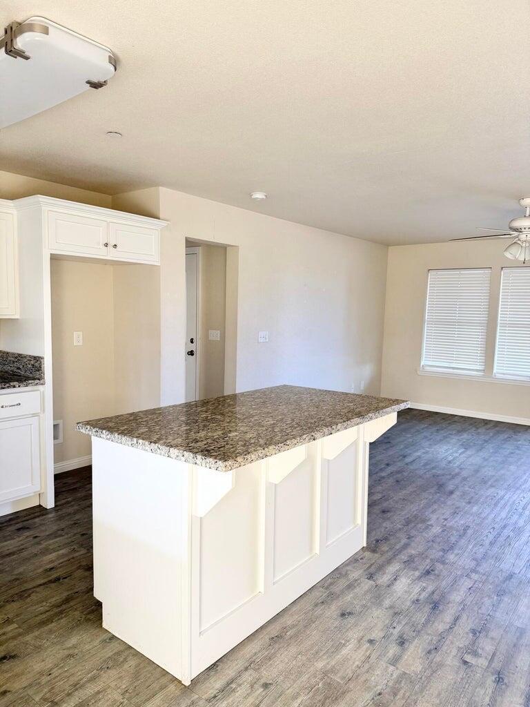 1310 North Belmont Road Exeter, CA 93221 - Photo 6 of 15 a kitchen with granite countertop a stove and a sink