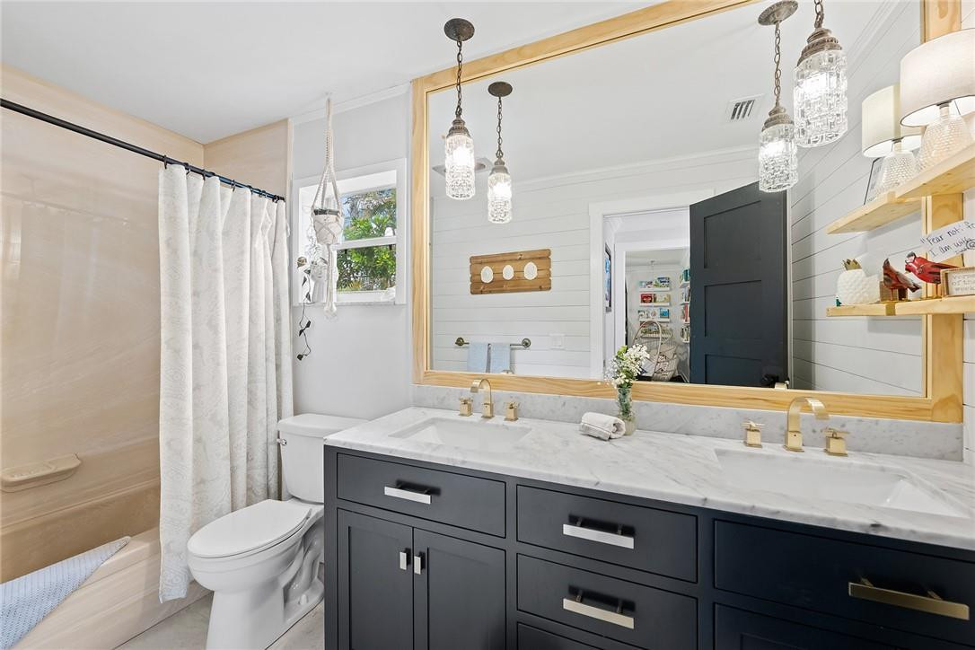 1621 Northwest 10th Street Boca Raton, FL 33486 - Photo 19 of 25 a bathroom with a granite countertop sink toilet and shower