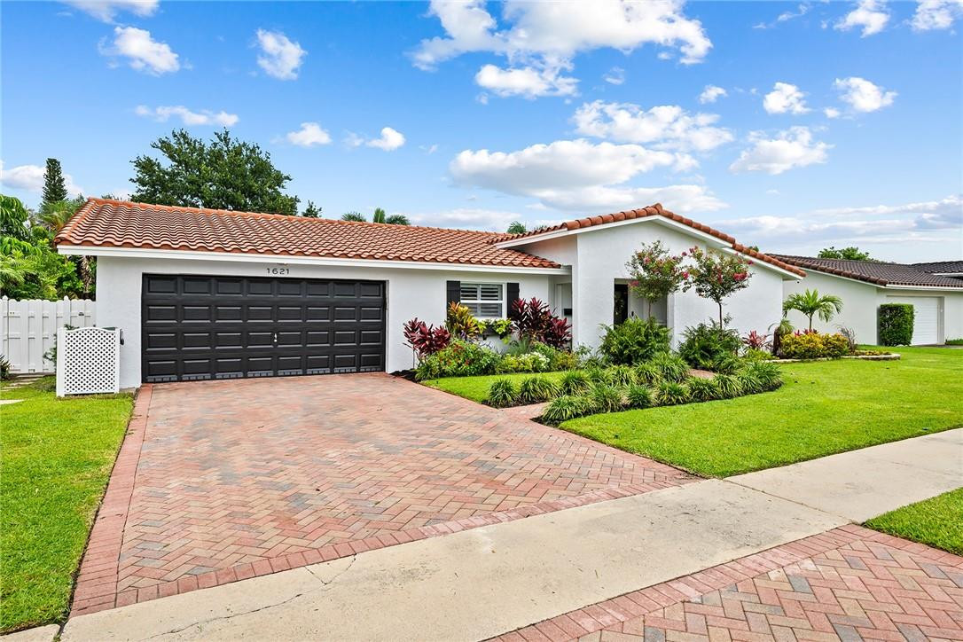 1621 Northwest 10th Street Boca Raton, FL 33486 - Photo 2 of 25 a front view of a house with garden