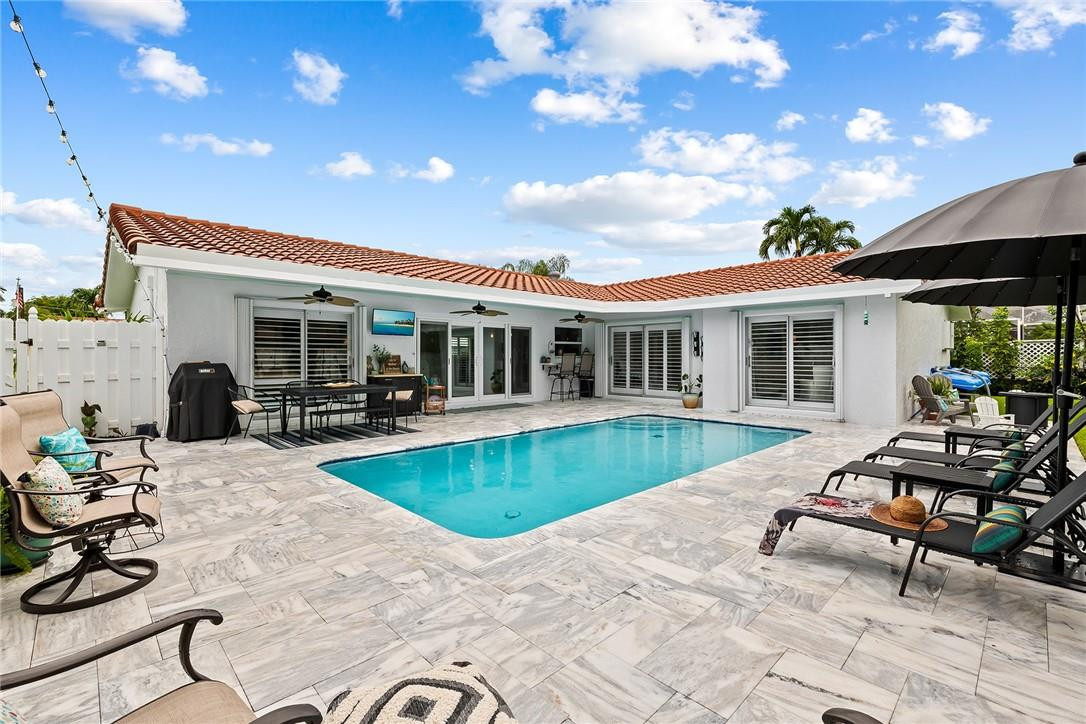 1621 Northwest 10th Street Boca Raton, FL 33486 - Photo 23 of 25 a view of a house with swimming pool