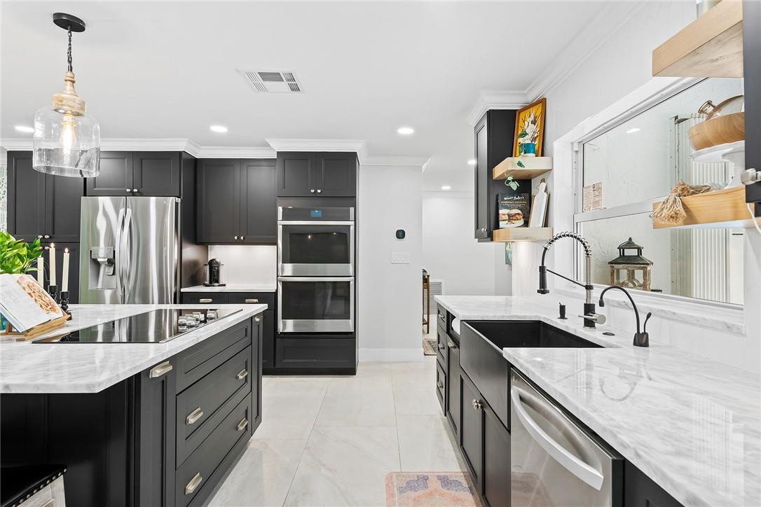 1621 Northwest 10th Street Boca Raton, FL 33486 - Photo 4 of 25 a kitchen with stainless steel appliances granite countertop a sink stove and refrigerator