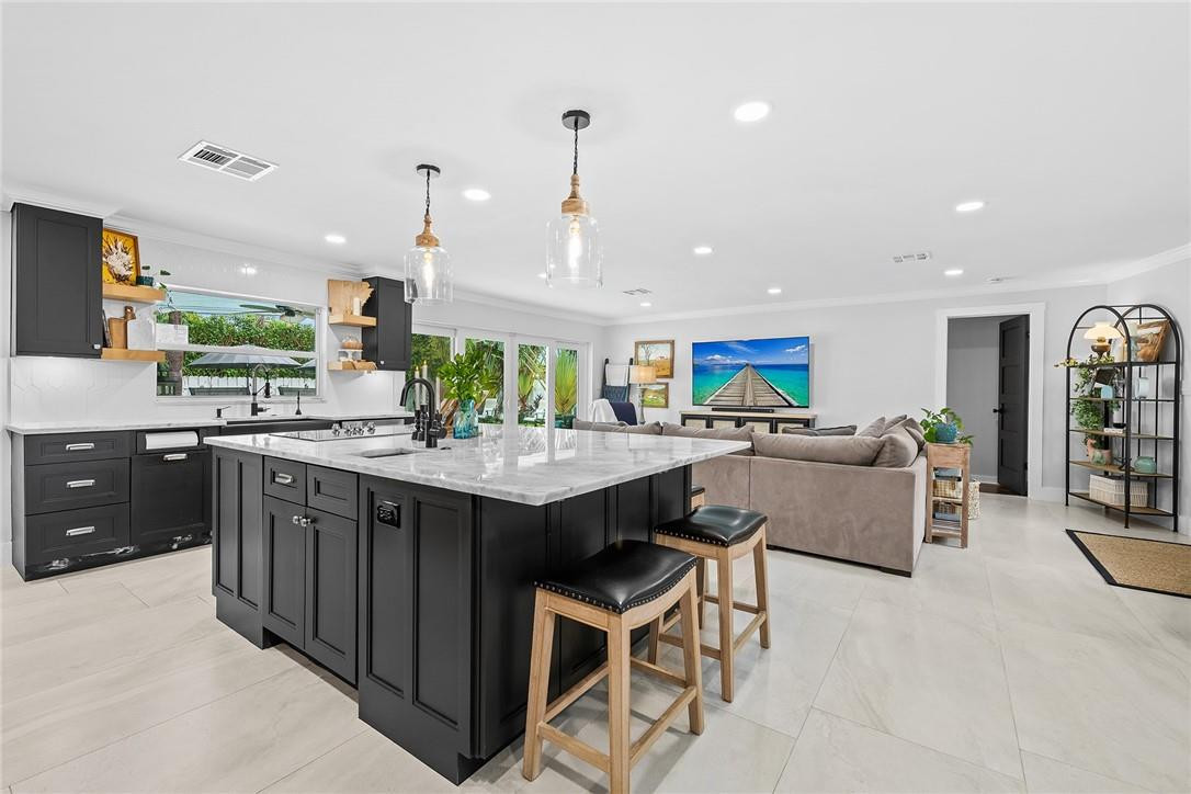 1621 Northwest 10th Street Boca Raton, FL 33486 - Photo 6 of 25 a kitchen with stainless steel appliances granite countertop counter space and a center island