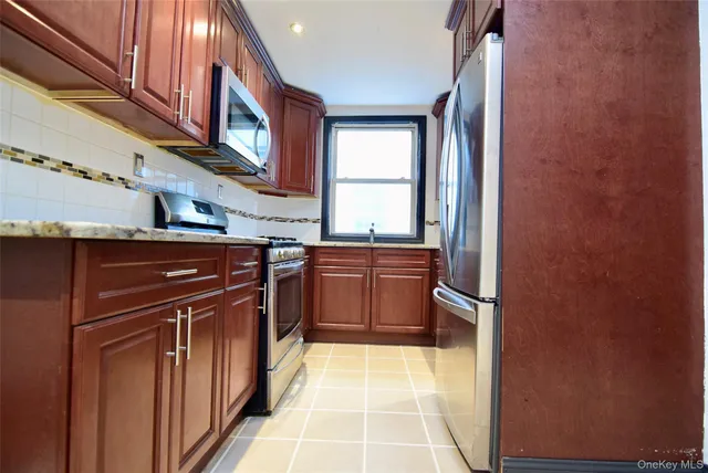 a kitchen with stainless steel appliances granite countertop a stove top oven a sink and dishwasher