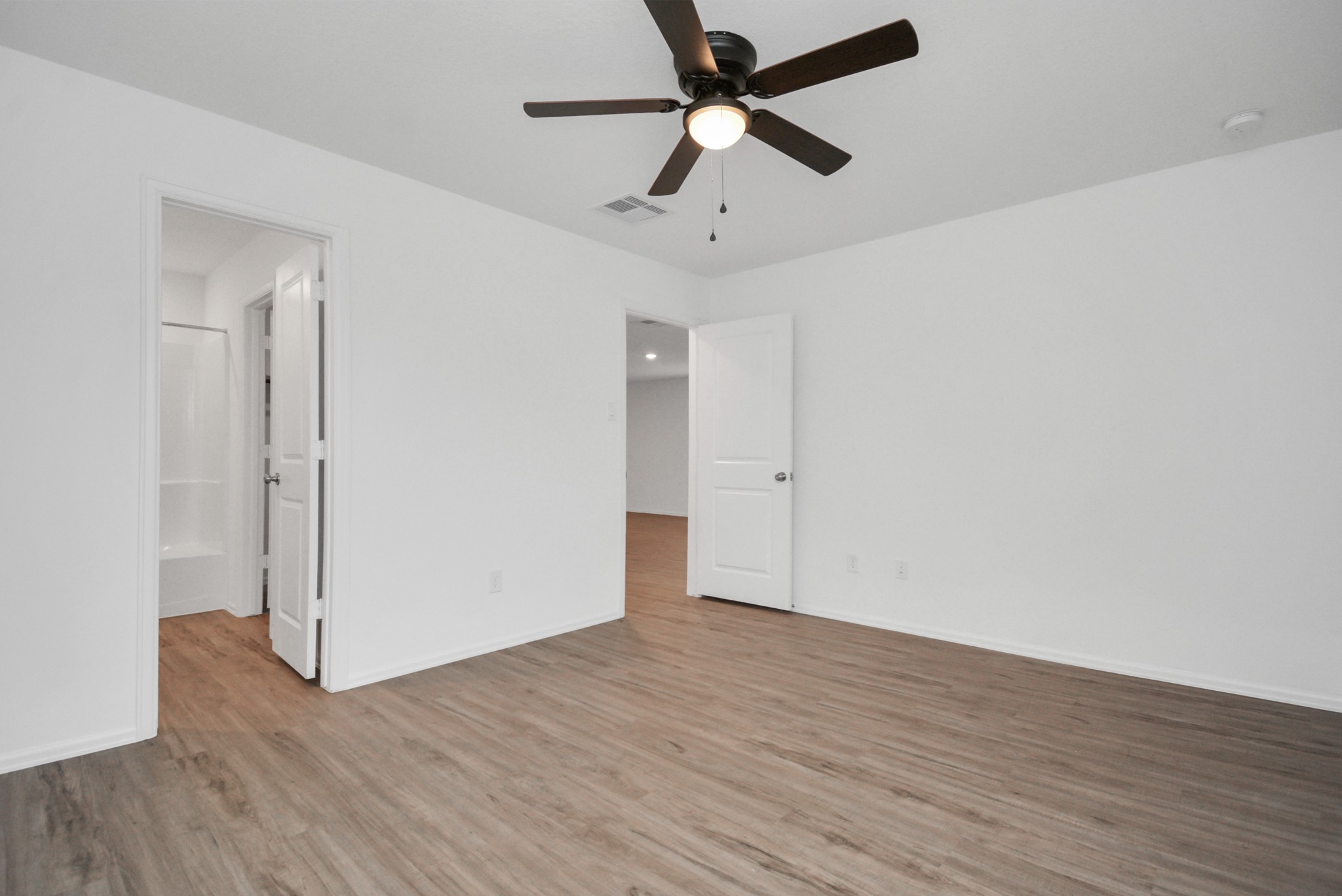 27023 Rimini Point Drive Katy, TX 77493 - Photo 11 of 15 an empty room with wooden floor and a ceiling fan