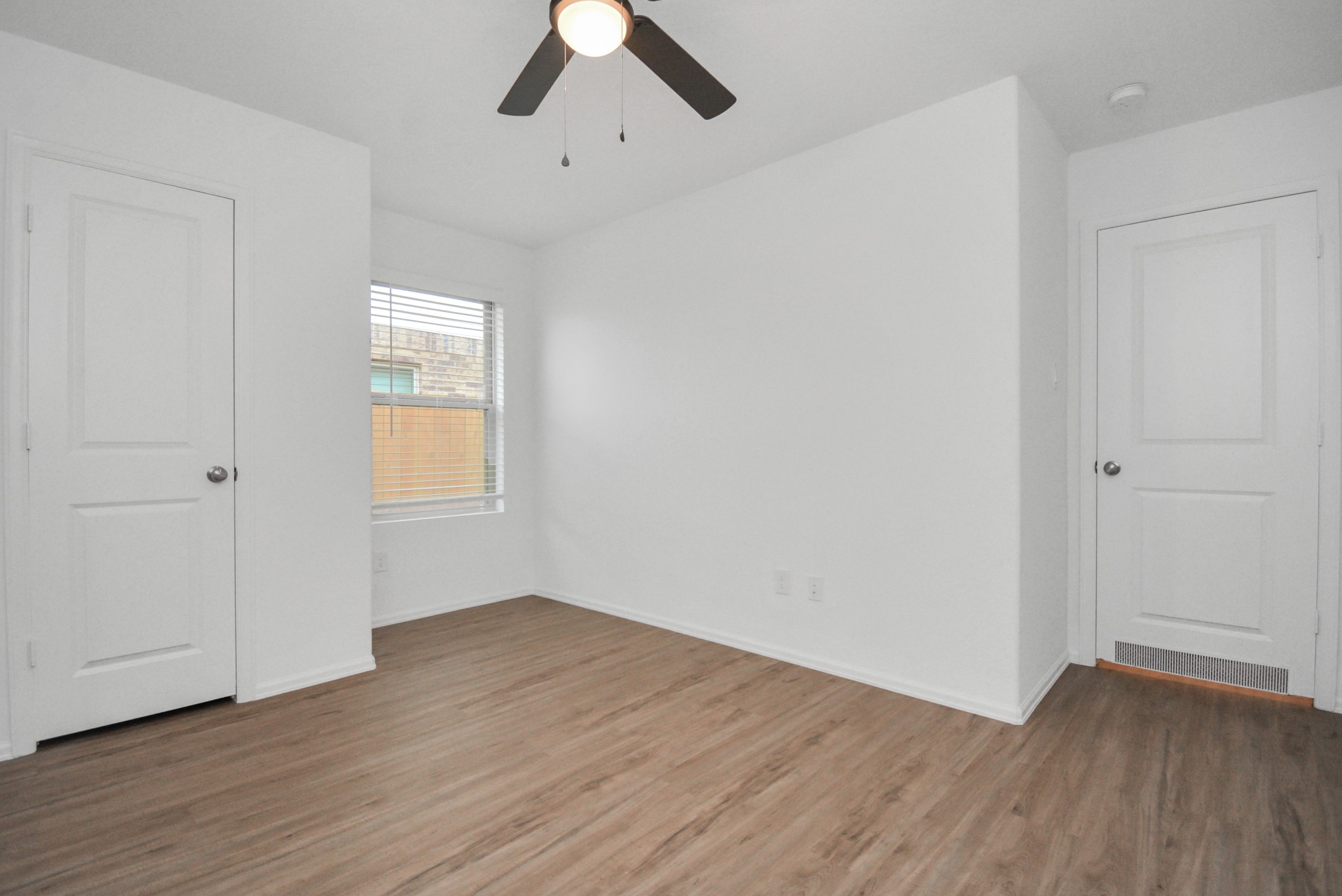 27023 Rimini Point Drive Katy, TX 77493 - Photo 15 of 15 an empty room with wooden floor cabinet and windows