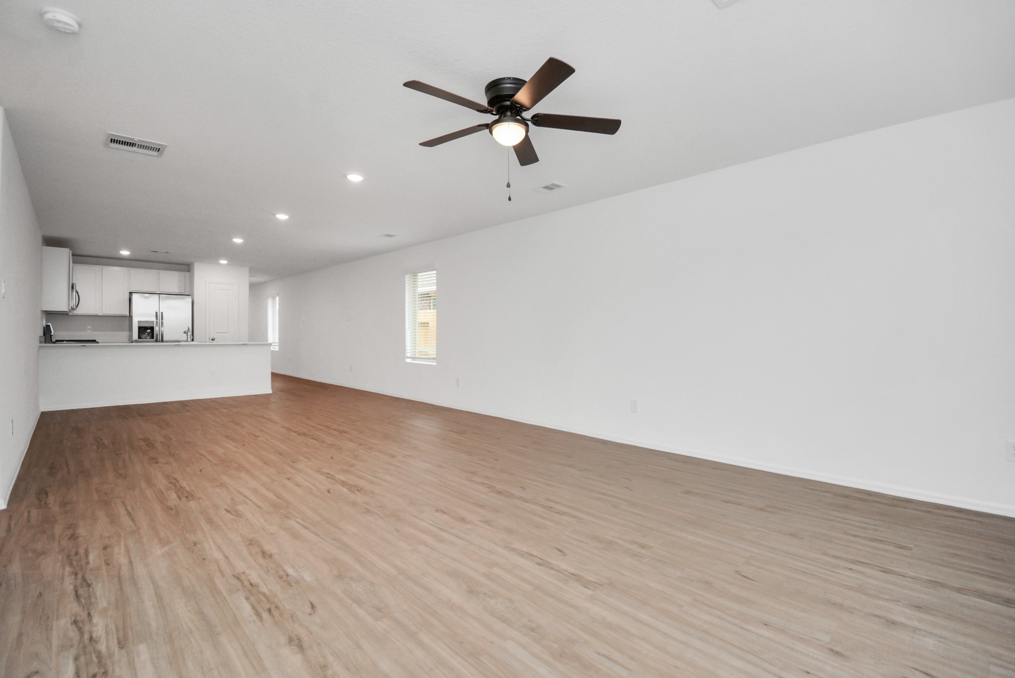27023 Rimini Point Drive Katy, TX 77493 - Photo 6 of 15 a view of empty room with wooden floor and ceiling fan