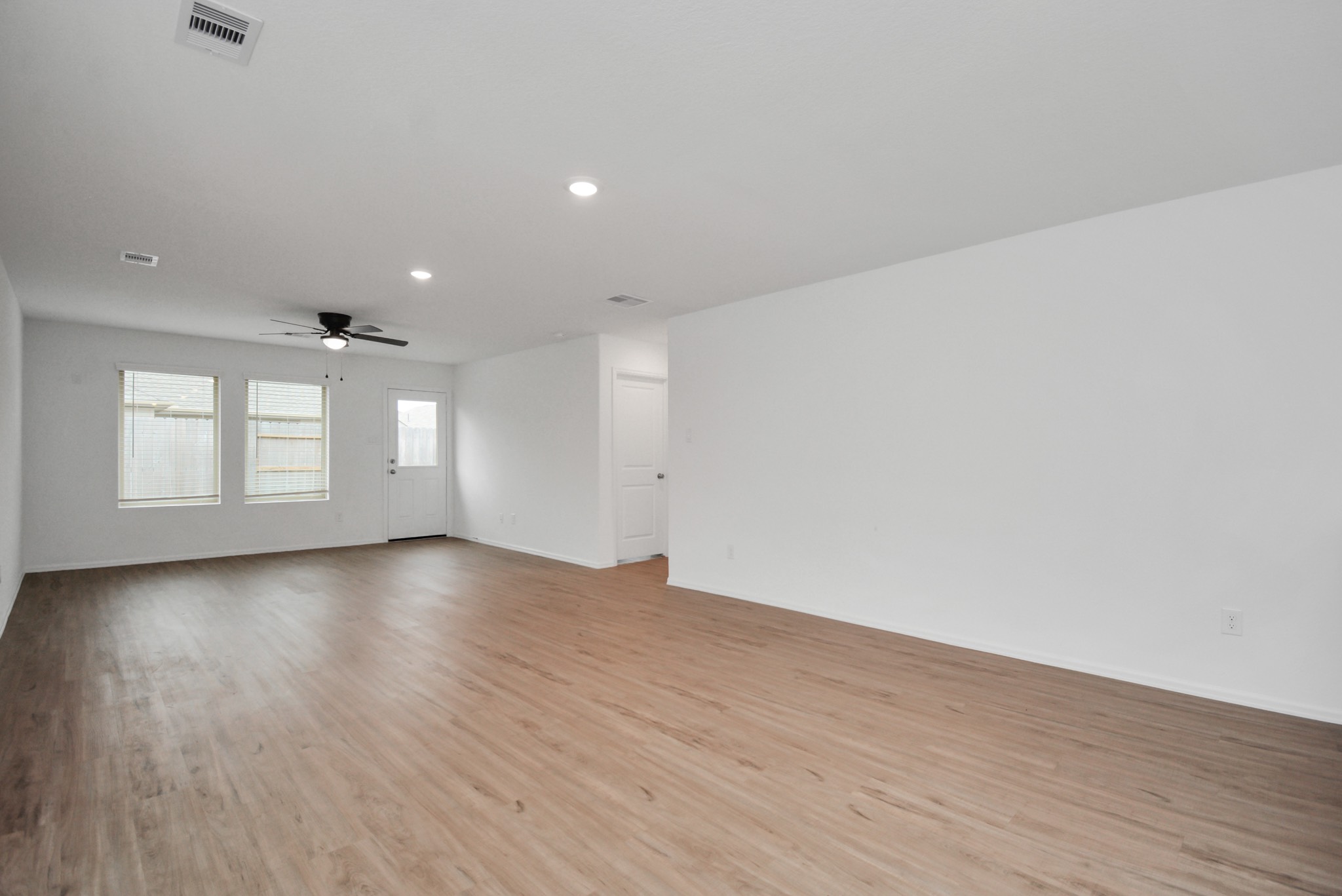 27023 Rimini Point Drive Katy, TX 77493 - Photo 10 of 15 a view of an empty room with wooden floor and window