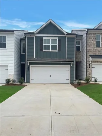 a front view of a house with garage
