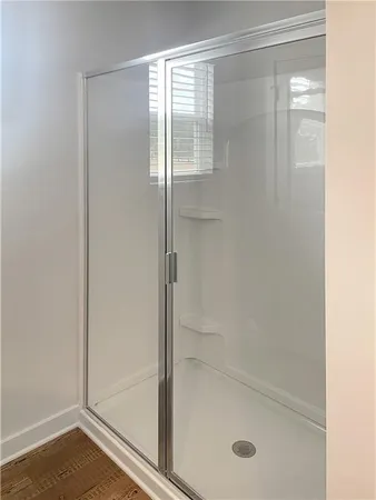 a bathroom with a glass shower door