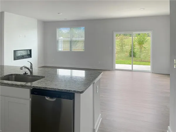 a kitchen with a sink a counter top space and a window