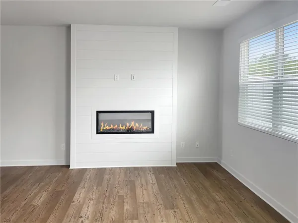 a view of a room with wooden floor and window