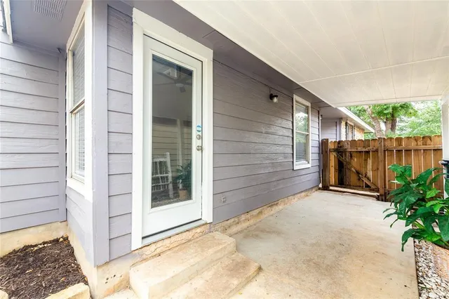 a view of backyard with tub and trees in the background