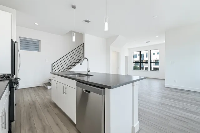 a kitchen with granite countertop a stove and a sink