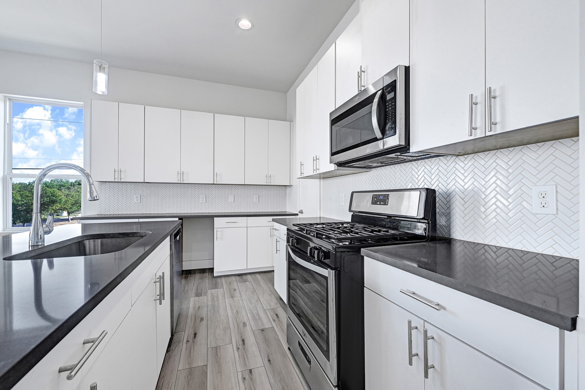 3313 Baer Street Houston, TX 77020 - Photo 12 of 26 a kitchen with stainless steel appliances granite countertop a stove a sink and a microwave