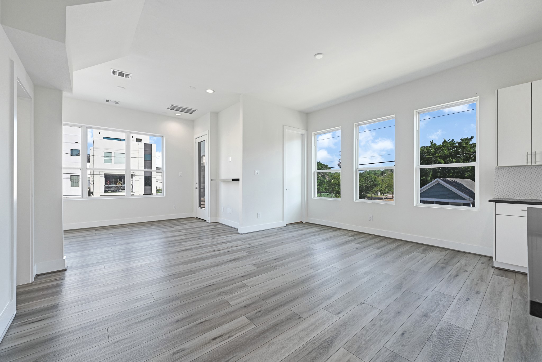 3313 Baer Street Houston, TX 77020 - Photo 13 of 26 a view of an empty room with wooden floor and a window