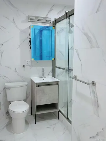 a bathroom with a toilet sink and shower