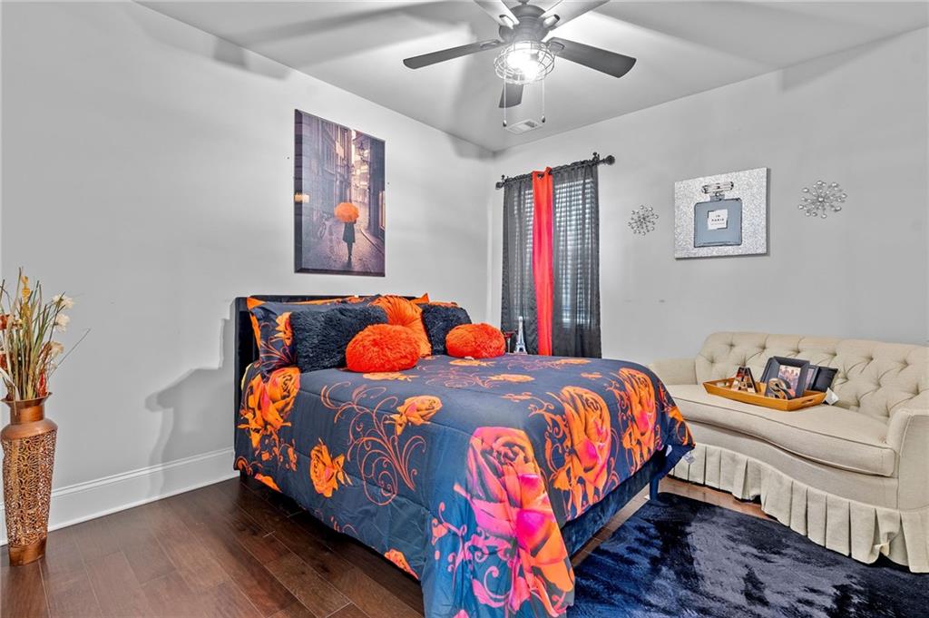 108 Fountain Oak Villa Rica, GA 30180 - Photo 11 of 45 a bedroom with a bed and a chandelier