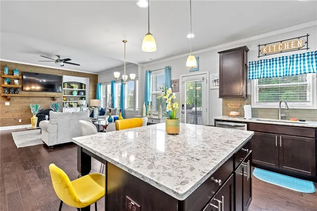 a kitchen with granite countertop a table and chairs