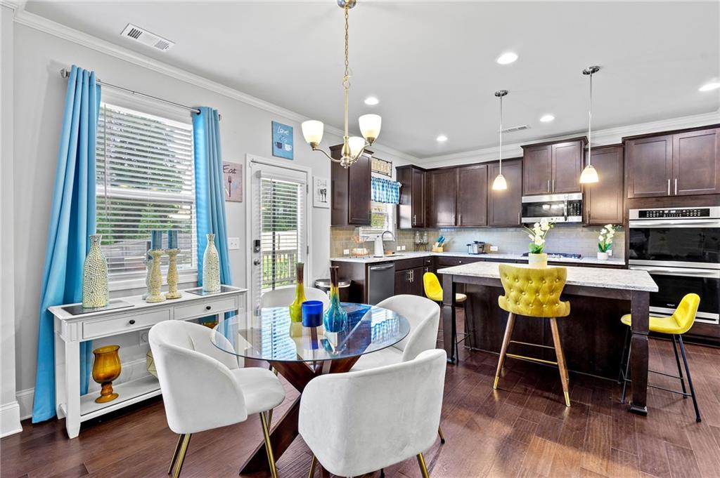 108 Fountain Oak Villa Rica, GA 30180 - Photo 16 of 45 a view of kitchen with stainless steel appliances granite countertop dining table chairs refrigerator and microwave