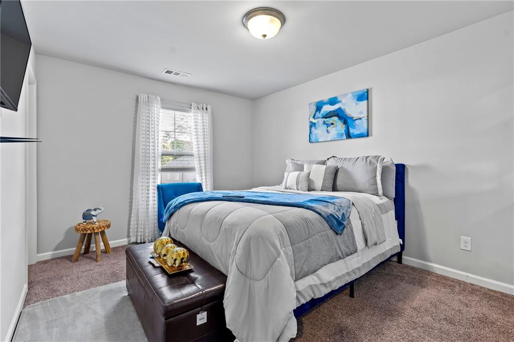 108 Fountain Oak Villa Rica, GA 30180 - Photo 20 of 45 a bed sitting in a bedroom next to a window