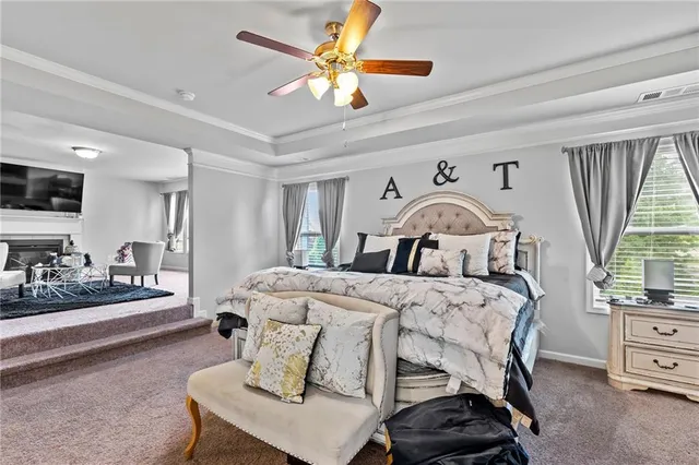 a bedroom with a bed and a tv on the dresser