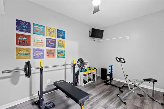 a work room with furniture and a flat screen tv