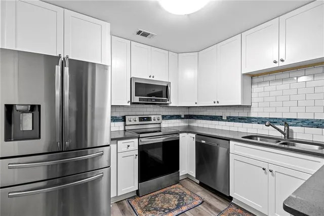 a kitchen with a sink stove and refrigerator
