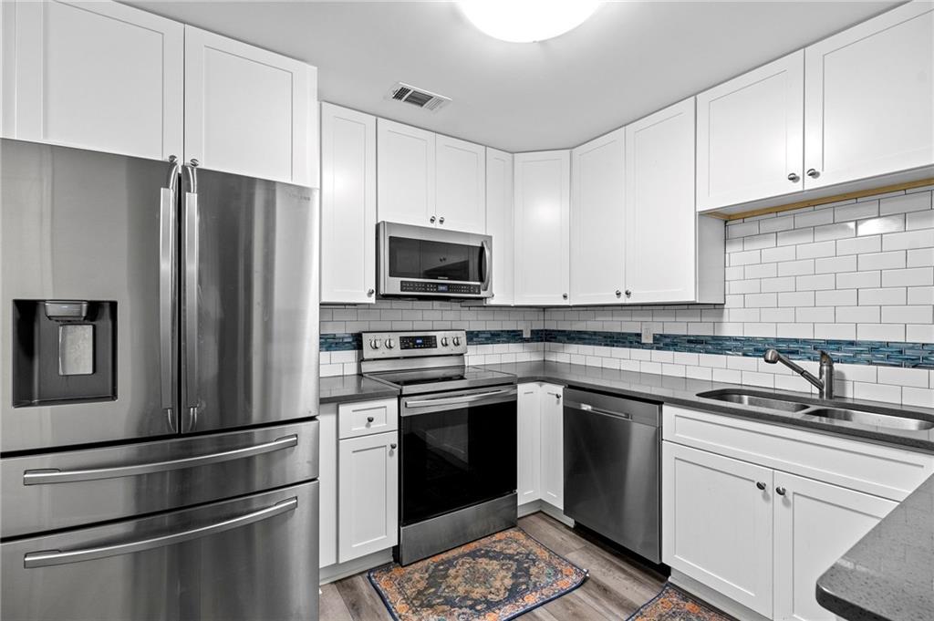108 Fountain Oak Villa Rica, GA 30180 - Photo 34 of 45 a kitchen with a sink stove and refrigerator