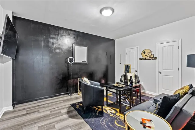 a living room with furniture and a flat screen tv