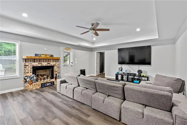 a living room with furniture a fireplace and a flat screen tv