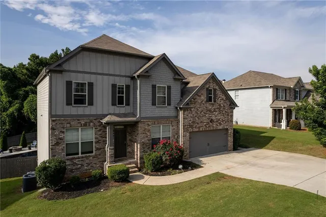 a front view of a house with a yard and garage