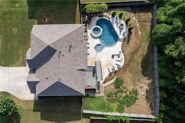 an aerial view of a house with outdoor space and pool