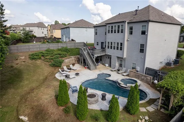 a view of a house with backyard and sitting area